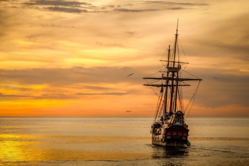Sailing ship at sunset representing The Odyssey in real life and Odysseus' journey across the Mediterranean